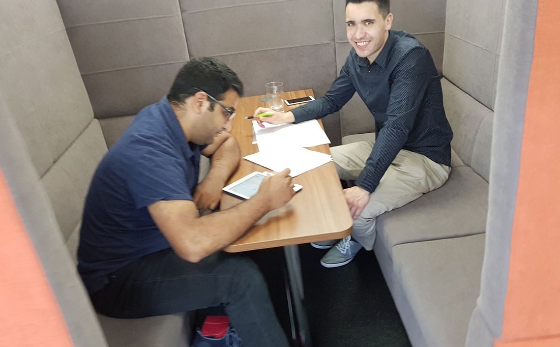 Two of the team working through a brief at a table